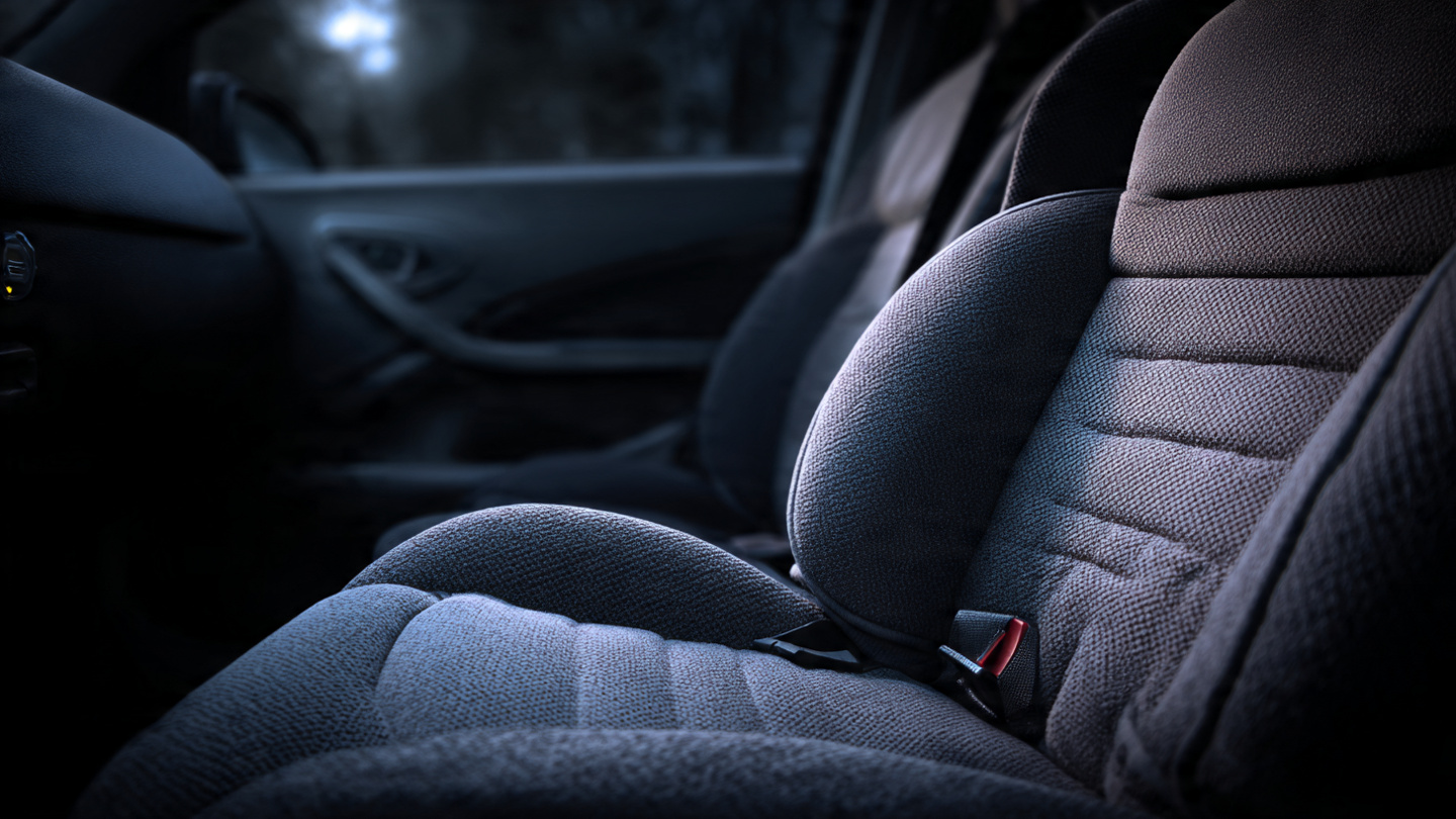 Empty child car seat in vehicle passenger seat with airbag compartment visible