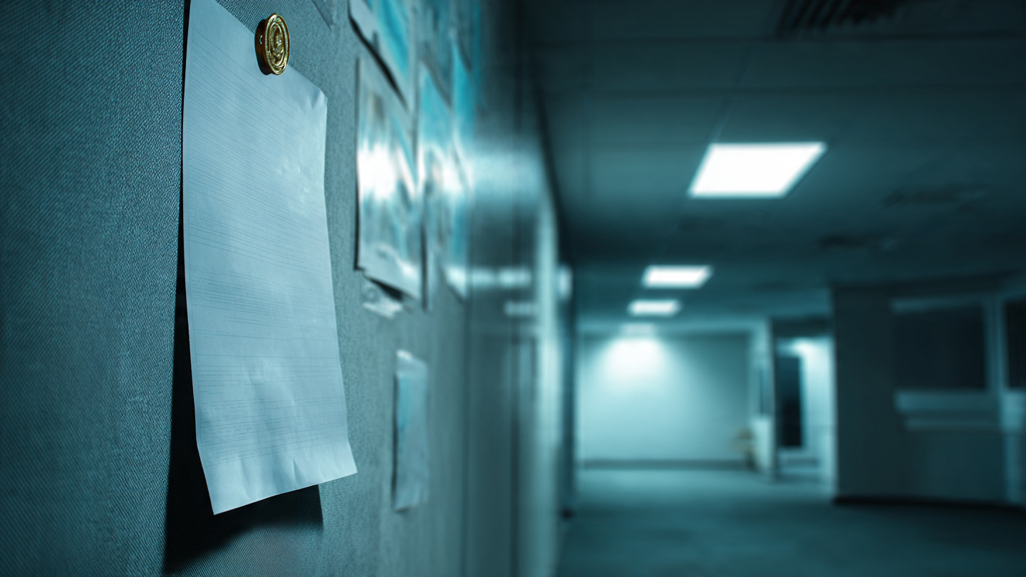Empty NHTSA recall notice pinned to a bare bulletin board in a dimly lit government office