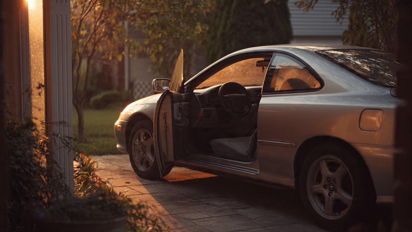 A silver Toyota Solara coupe in a quiet suburban driveway at dusk