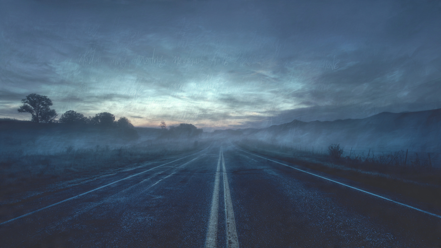 A fog-shrouded American highway stretching into the distance at dawn, evoking the unreachable 2014 safety record
